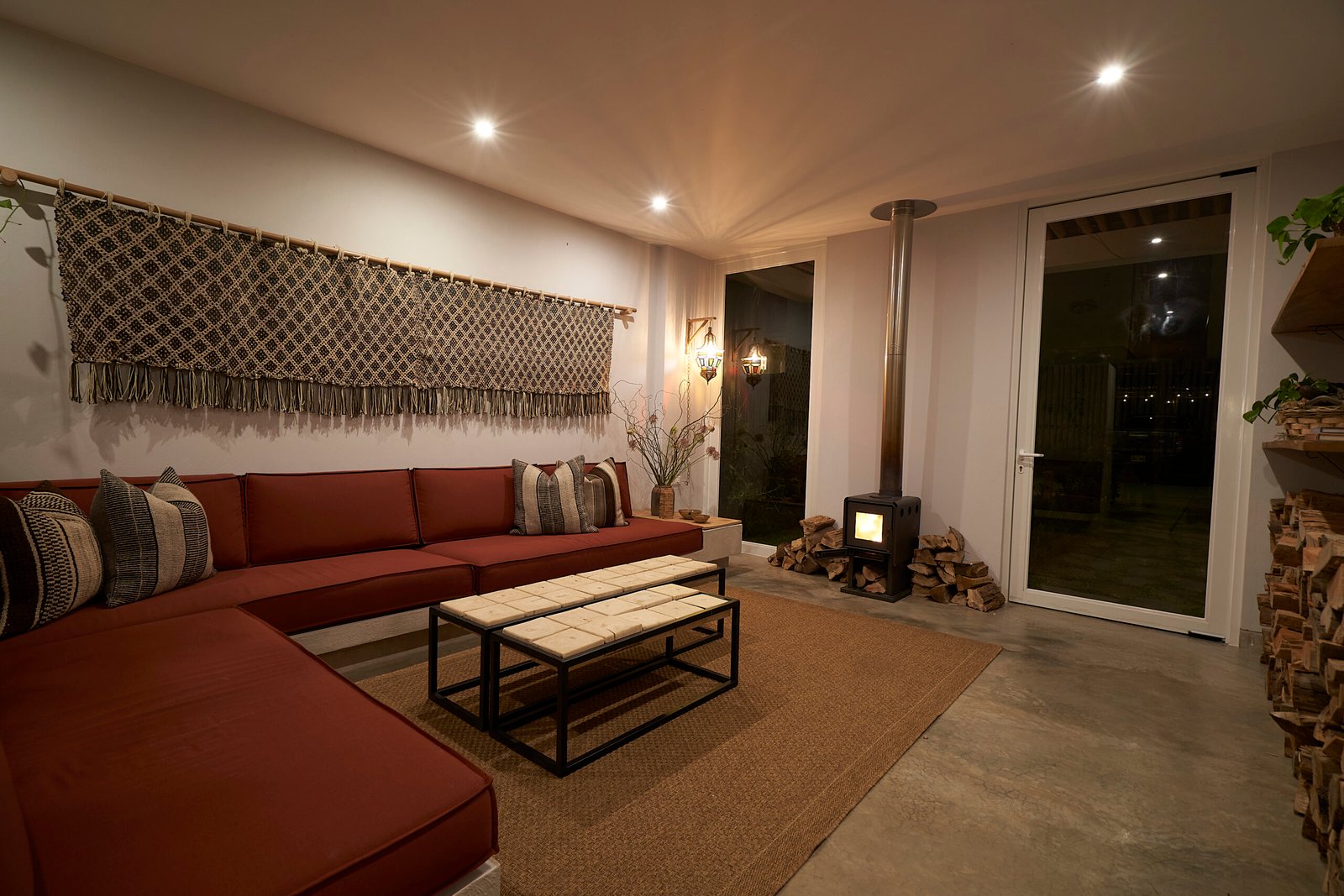 Casa Raiz bedroom with loft bunk, beige headboard and curtained patio doors at night, by Alexander Estrada